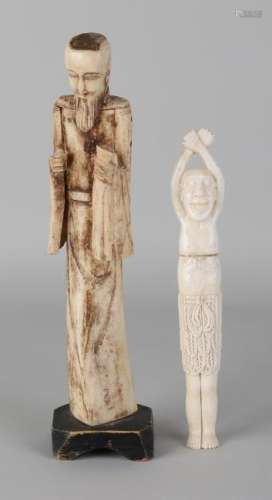 Two old carved legs figures. 20th century. Consisting