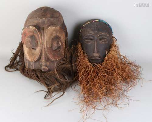 Two old polychrome African woodcarved masks with rope