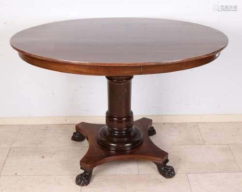 Antique mahogany oval Empire table with four claw feet.