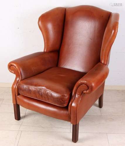 Brown leather chair with patina and wooden legs. Second