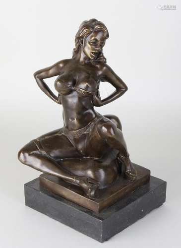 Bronze erotic lady with suspenders. On black marble