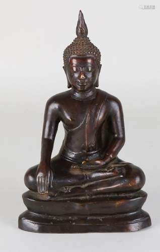 Old / antique bronze Oriental buddha in lotus position.