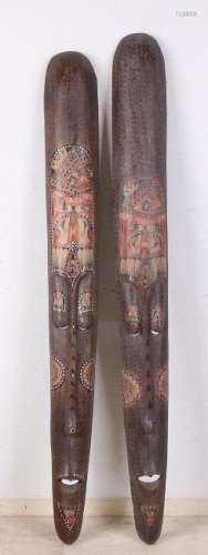 Two African wooden shields in heads-forms. Painted and