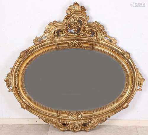 Large 19th century gold colored oval mirror with crown.