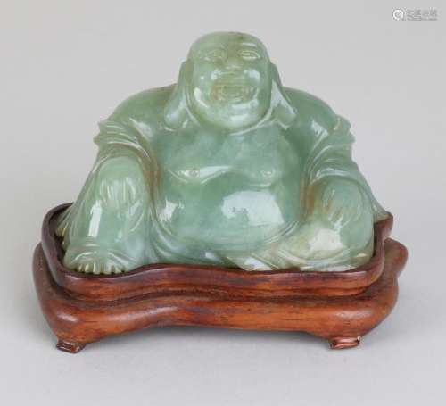 Old Chinese jade buddha on wood-stained console. Size: