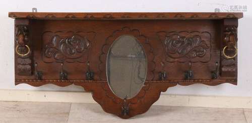 Antique oak wall wardrobe with lion heads and mirror.