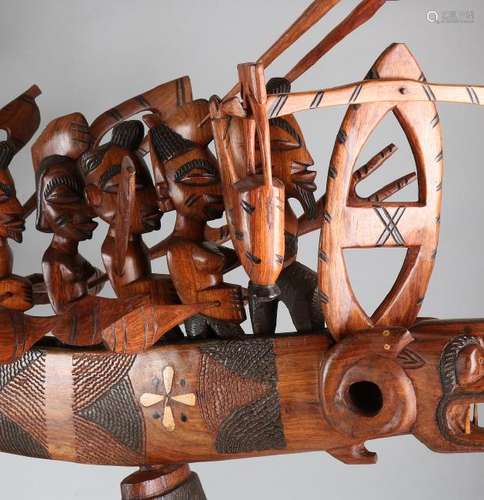 Large African tropical wooden boat with male and female