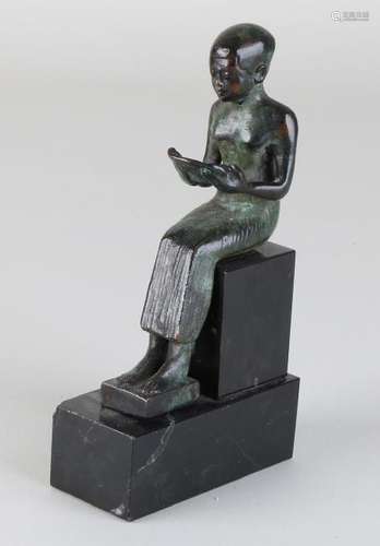 Egyptian bronze figure on black marble base. 20th