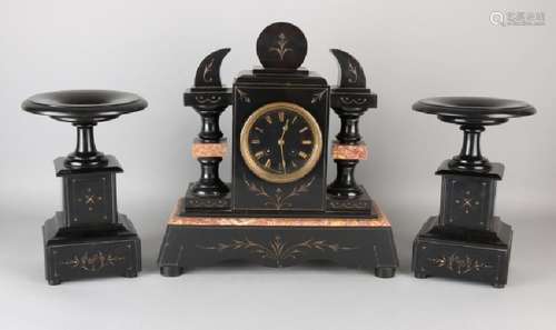 Antique French black marble clock set with coupes.