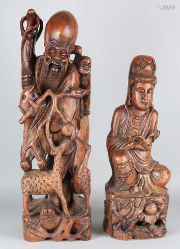 Two old Chinese wood-stained statues. Quan Yin and