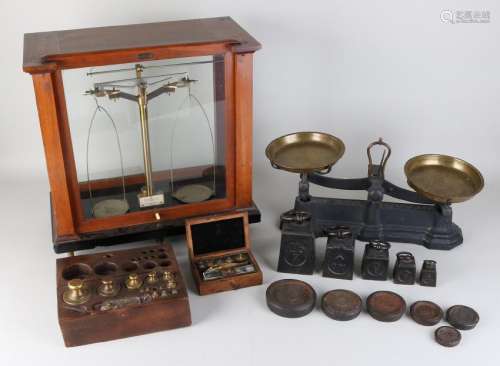 Two antique scales with three weights sets. One time
