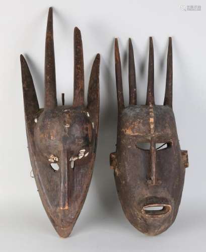 Two large African woodcarved masks with shells. Size: