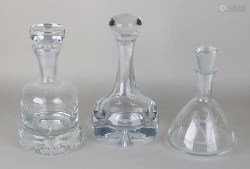 Three modern crystal glass decanters. Twice with air