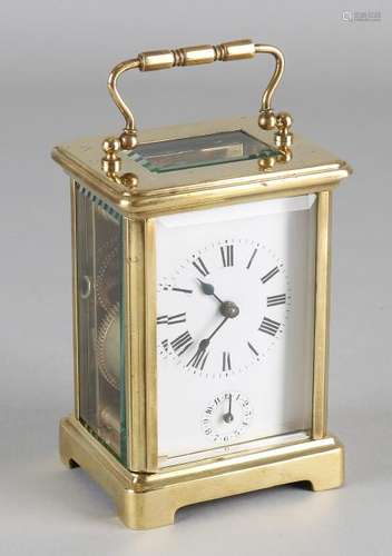 Old brass travel alarm clock with seconds indication