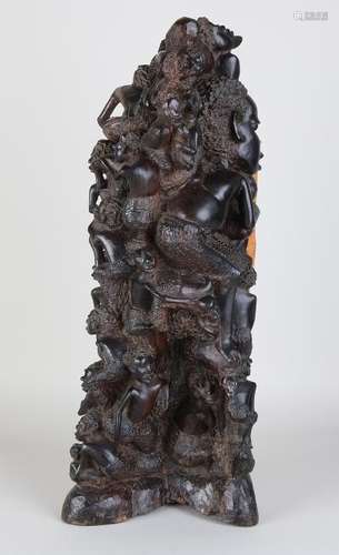 Large African wood-stoned statue with many figures.