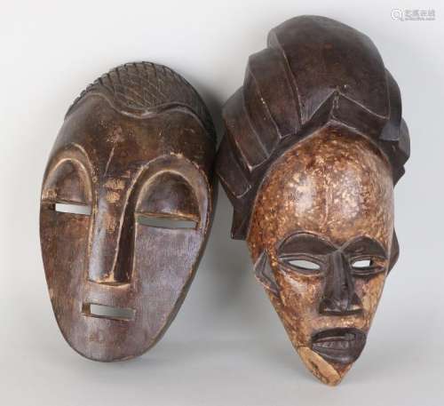Two old African wood-stained masks. 20th century. Size: