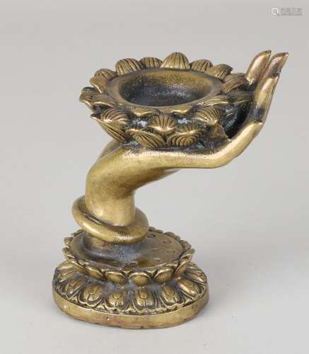 Old Chinese bronze offering dish. Lotus on hand. Soil