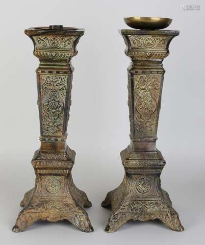 Two decorative old carved bronze candle candlesticks.