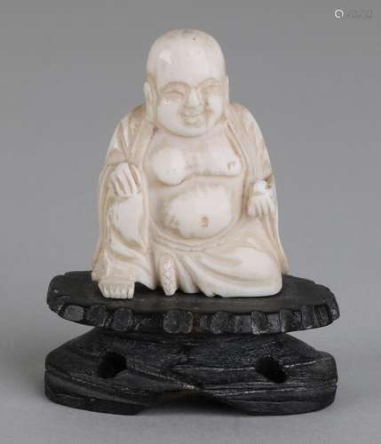 Antique Chinese ivory laughing buddha on wood-stained