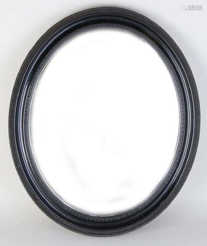 Antique oval black mirror with carved edge and facet