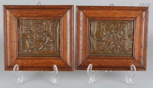 Two antique bronze plaques in oak frames. Interiors