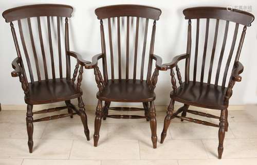 Three English Windsor armchairs made of beech wood.