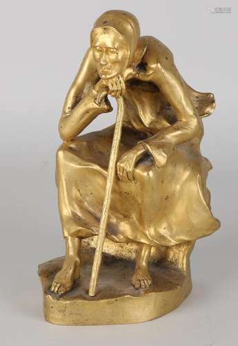 Antique gilt bronze figure. Old woman with walking