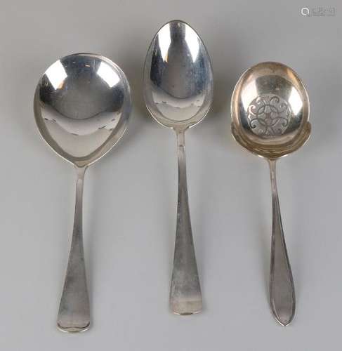 Three silver serving spoons, 833/000, a rice spoon