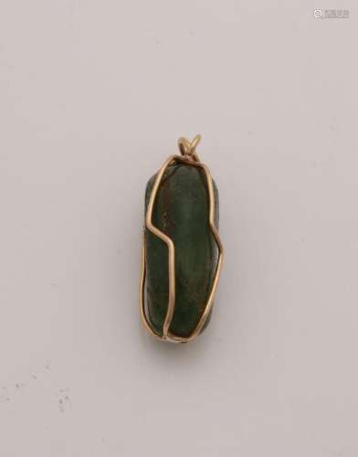 Jade stone caught in a yellow gold cupboard made of