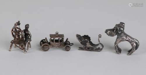 Four silver miniatures, 835/000, with a woman behind a