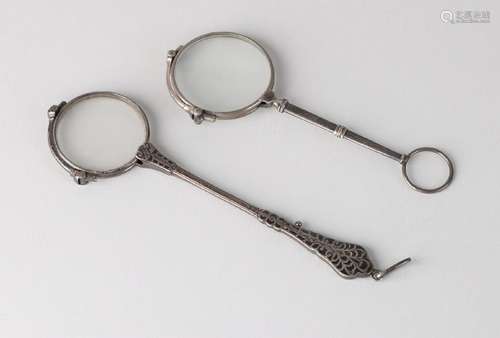 Two silver longnet glasses, one with a handle with