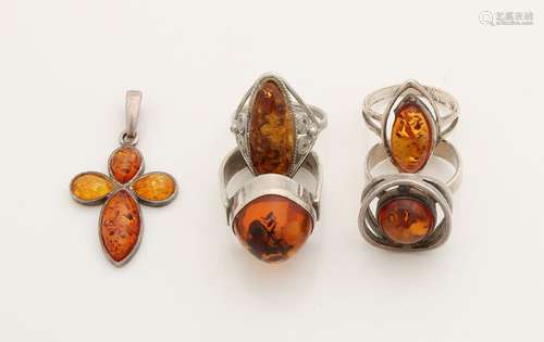 Lot of silver jewelry with amber, three rings with an