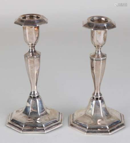 Two silver table candlesticks, 835/000, on an octagonal