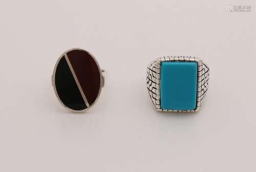 Two silver rings, one with an oval case with black and