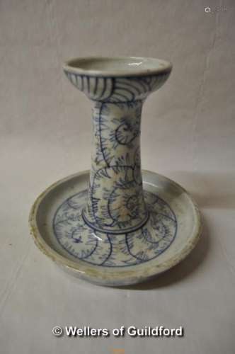 A Chinese blue and white candlestick with integral drip tray, 15cm high.