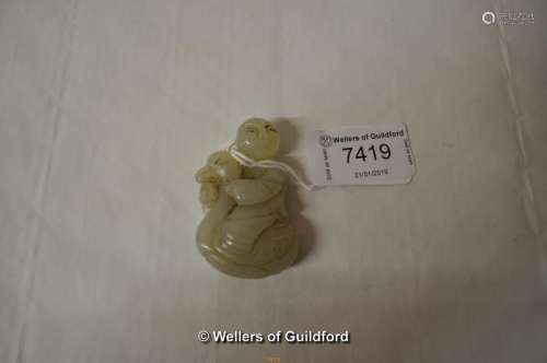 A Chinese pale green jade pendant carved as a boy sitting on a duck, 5cm.