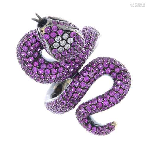 A gold sapphire and diamond snake ring. Designed as a