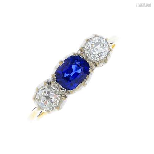 A sapphire and diamond three-stone ring. The oval-shape