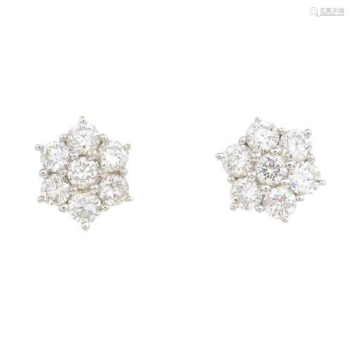 A pair of diamond cluster earrings. Each designed as a