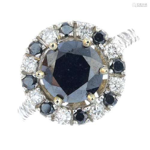 A black gem and diamond cluster ring. The
