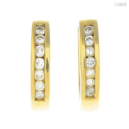 A pair of 18ct gold diamond earrings. Each designed as