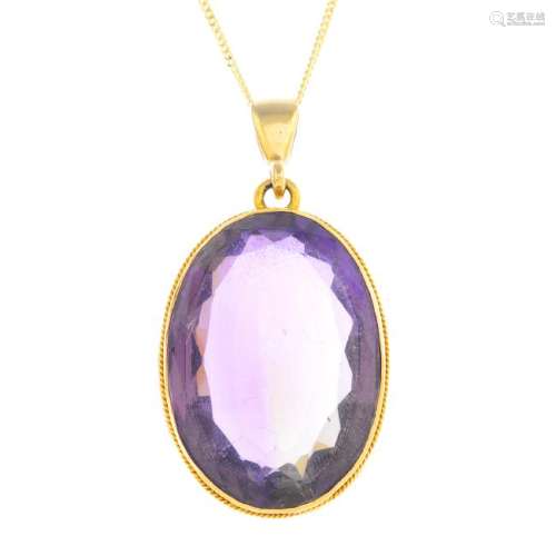 An amethyst pendant. The oval-shape amethyst, with