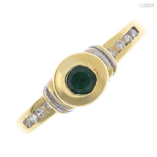 An emerald and diamond dress ring. The circular-shape