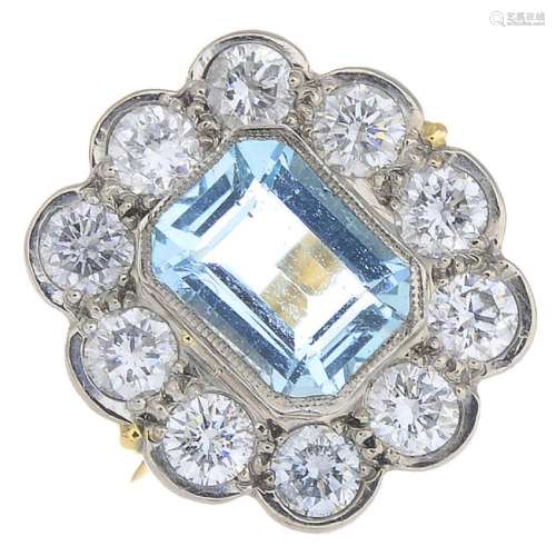 An 18ct gold aquamarine and diamond cluster ring. The