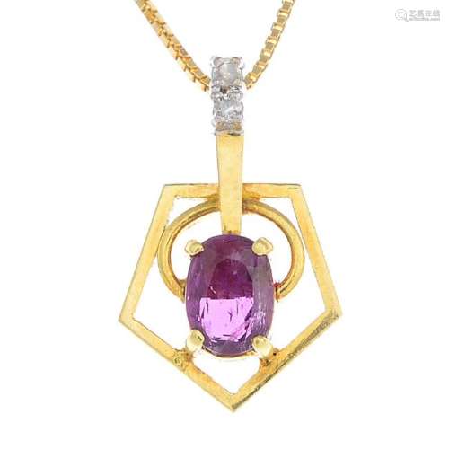 A ruby and diamond pendant. The oval-shape ruby, with