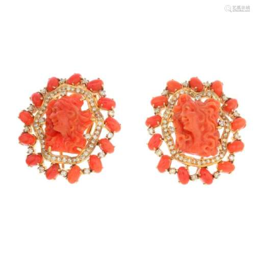 A pair of coral and diamond earrings. Each designed