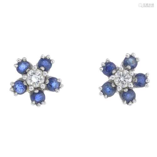 A pair of sapphire and diamond stud earrings. Each
