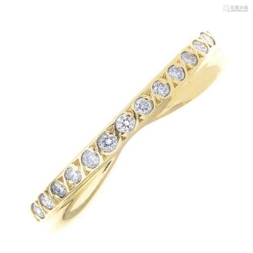 An 18ct gold diamond band ring. Designed as a