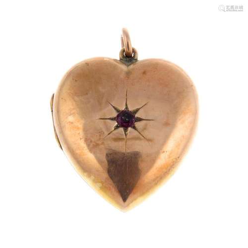 An Edwardian 9ct gold ruby heart locket. The