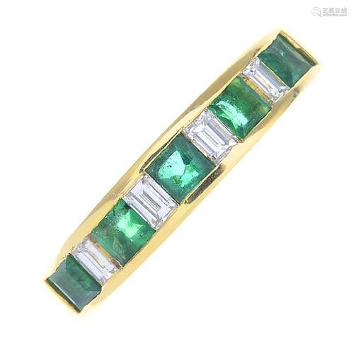 An 18ct gold emerald and diamond half eternity ring.